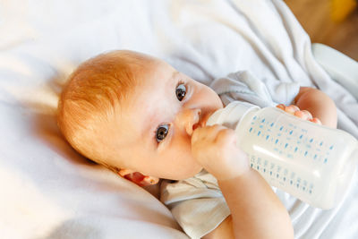 Portrait of cute baby boy sleeping on bed at home