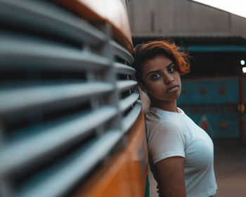 Side view portrait of young woman standing outdoors