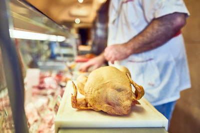 Midsection of man preparing food