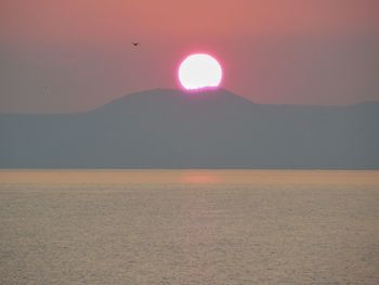 Scenic view of sea against clear sky during sunset