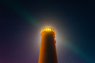 Low angle view of lighthouse against sky at night