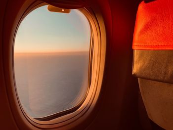 Sky seen through airplane window during sunset