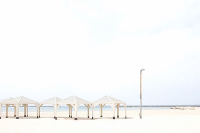 Built structure on beach against clear sky