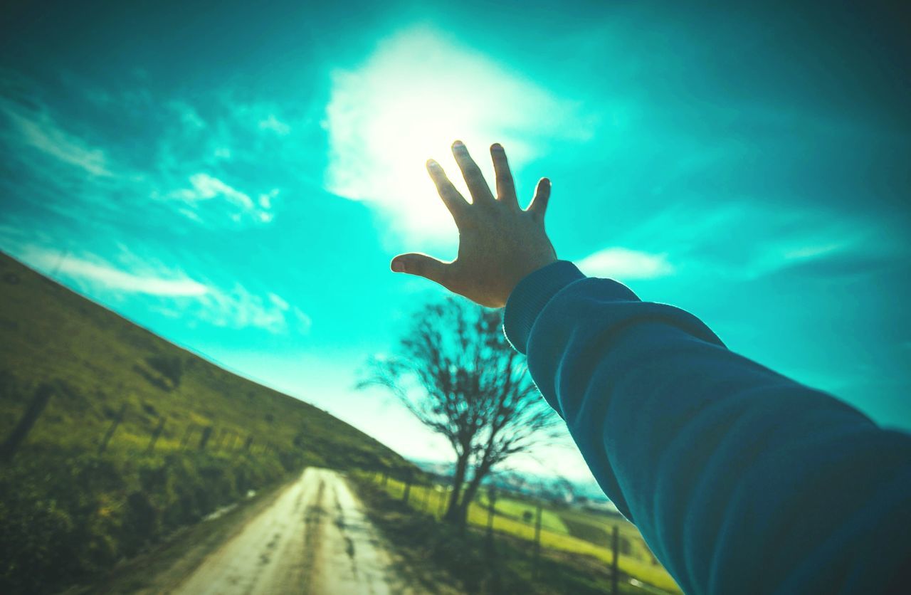 PERSON HAND REACHING TOWARDS SKY