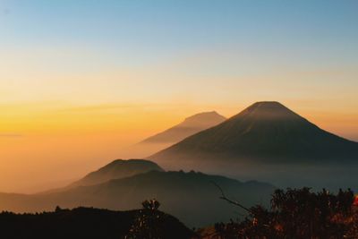 Scenic view of silhouette mountains against sky during sunset