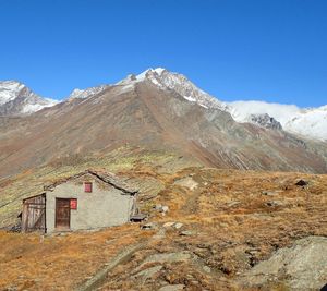 Scenic view of snowcapped mountains against blue sky