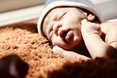 Close-up of baby boy sleeping at home