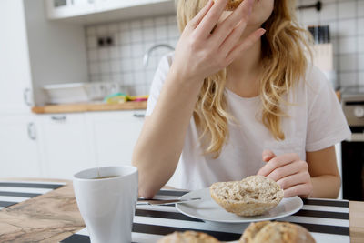 Midsection of woman having food