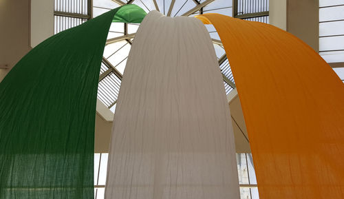 Low angle view of irish flag hanging on skylight