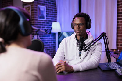 Man and woman podcasting in studio