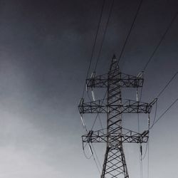 Low angle view of electricity pylon against sky
