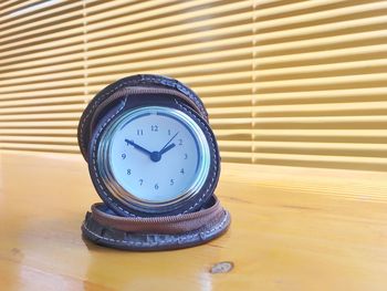 Close-up of clock on table