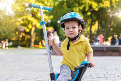 Portrait of cute boy riding