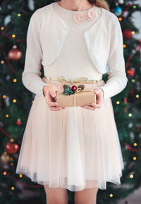 Midsection of a girl holding christmas present