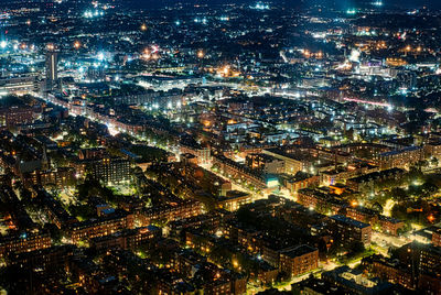 High angle view of city lit up at night