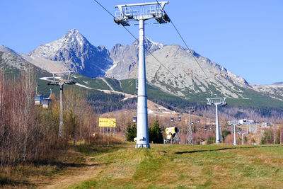 Built structure on field by mountain against sky