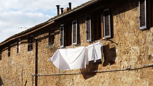 Clothes hanging outside window of building