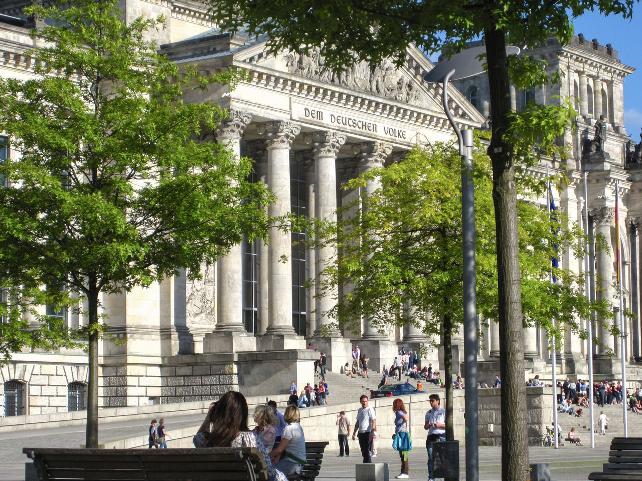 architecture, tree, architectural column, plant, built structure, group of people, travel destinations, city, day, tourism, nature, history, travel, the past, crowd, building exterior, real people, large group of people, men, outdoors