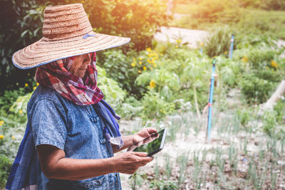 Senior woman using digital tablet at yard