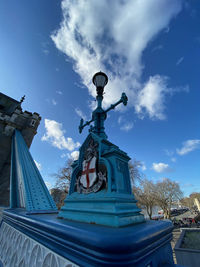 Low angle view of statue against building against sky