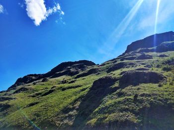 Low angle view of mountain against blue sky