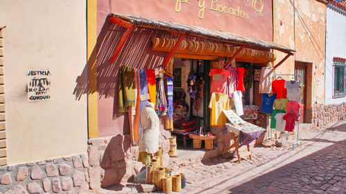 Clothes hanging outside building at market