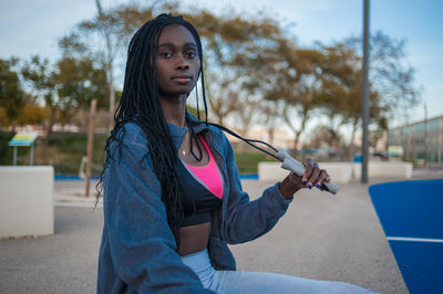 Portrait of young woman sitting outdoors