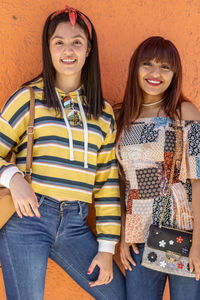 Portrait of cheerful women with straight hair and casual dress showing their support and respect 