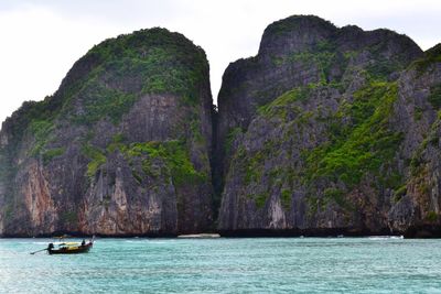 Scenic view of sea and mountains against sky