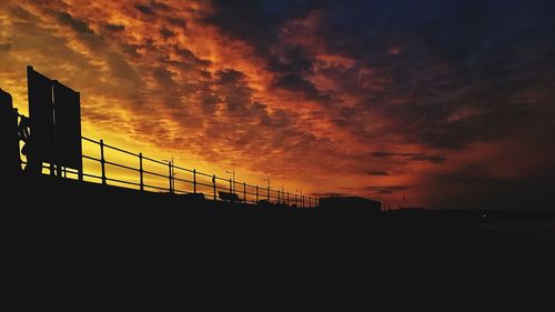 Silhouette of building against dramatic sky