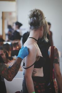 Side view of woman getting tattoo at munchenbryggeriet