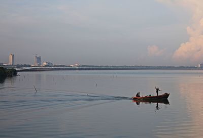 Scenic view of river against sky during sunset