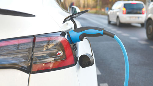 Electric vehicle charging at public charging station. new energy vehicles, alternative energy