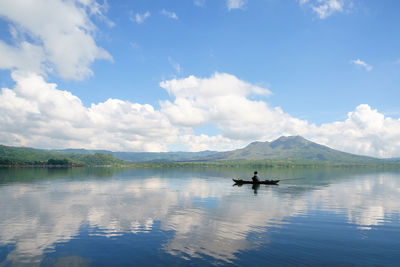 Boat with reflection of clouds in lake