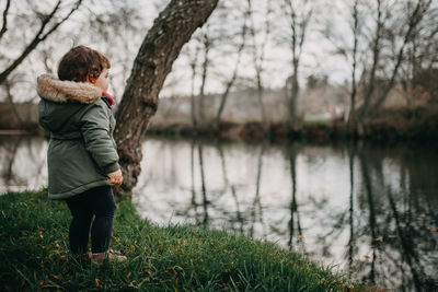 Full length of child standing by river