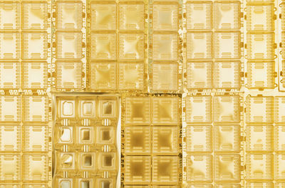 Full frame of gold colored plastic packaging