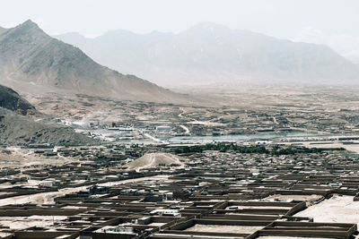 High angle view of townscape and mountains against sky