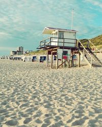 Lifeguard hut on beach against sky