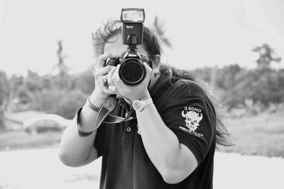 Portrait of man photographing camera