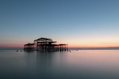 Scenic view of sea against clear sky during sunset