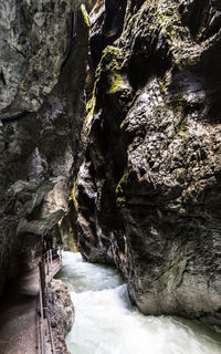 Scenic view of river flowing through cave