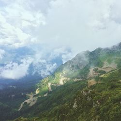 Scenic view of mountains against cloudy sky