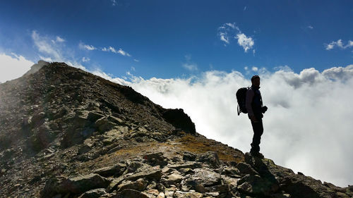 Low angle view of mountain against cloudy sky