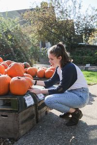 Full length of teenage girl sitting at park