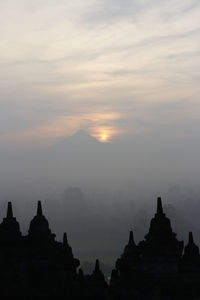 Silhouette temple against sky during sunset