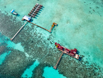 Aerial view of water chalet in egang egang near bum bum island during sunrise.