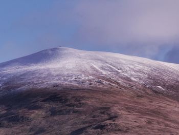 Low angle view of volcanic mountain against sky