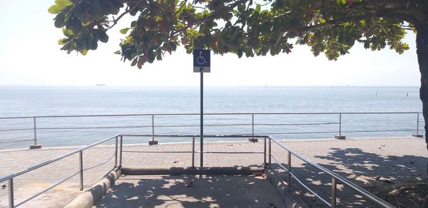 Scenic view of swimming pool by sea against sky