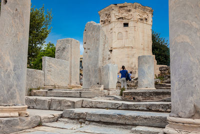 Tourists visiting the ancient ruins at the roman agora in athens