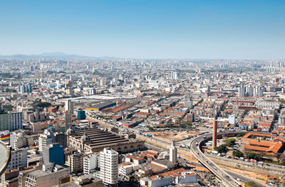 High angle view of modern buildings in city against clear sky